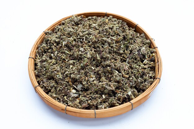 Dried absinthe wormwood in bamboo basket on white background.