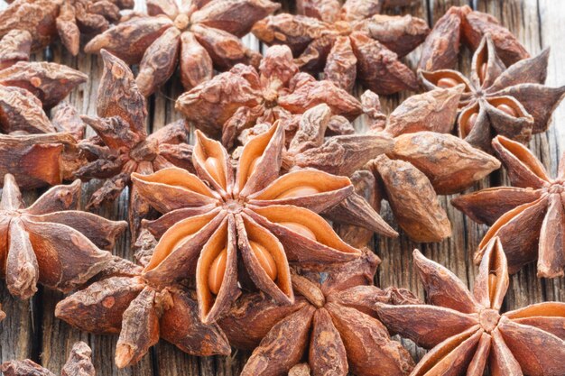 Dried Anise seeds on wooden table close up