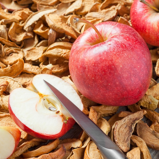 Dried apple slices knife and red fresh red apple fruit