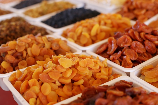 Dried apricots, dried fruits, on the market counter.