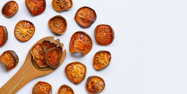 Dried bael fruit on white