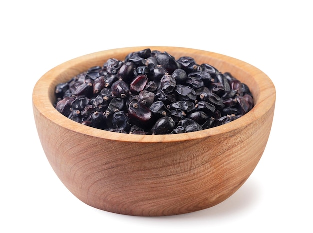 Photo dried barberry in a wooden plate closeup on a white background isolated