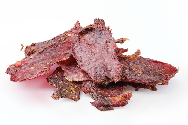 Dried beef jerky slices isolated on white background