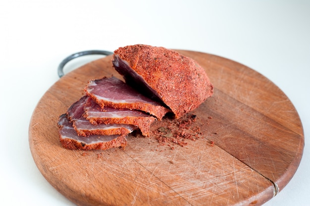 Dried beef. Sliced beef jerky. Meat on a wooden board.