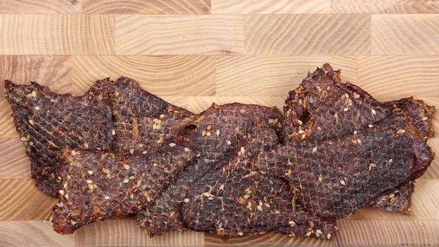 Dried beef slices in spices with sesame seeds