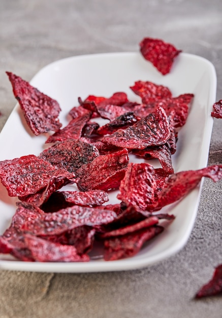 Dried beetrott chips on plastic tray