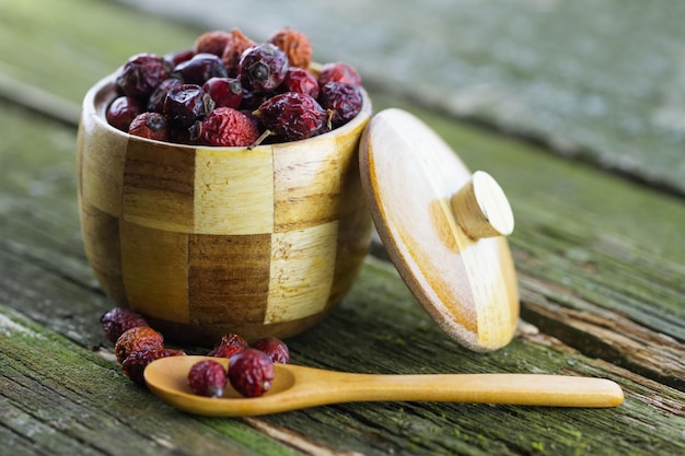 Dried berries in a wooden pot with a spoon