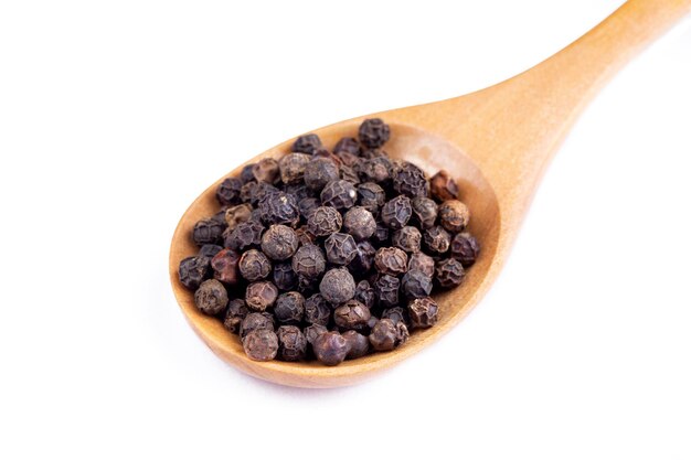 Dried black pepper on the white background