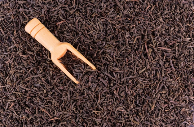 Dried black tea leaves background