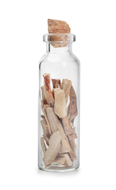 Dried calamus in glass bottle on white background