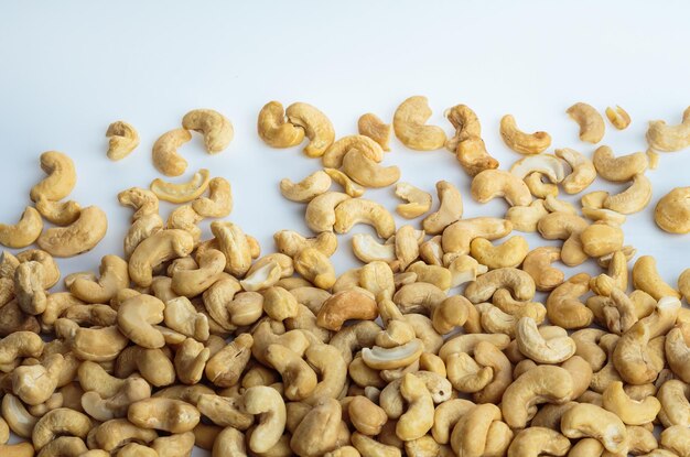 Dried cashew nuts on white background Cashew nuts scattered on white isolated