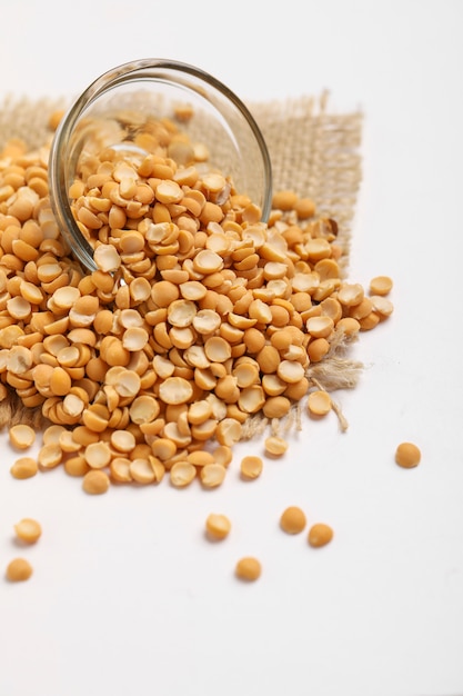 Dried chickpea lentils in Glass bowl on white background , Split Chickpea Also Know as Chana Dal