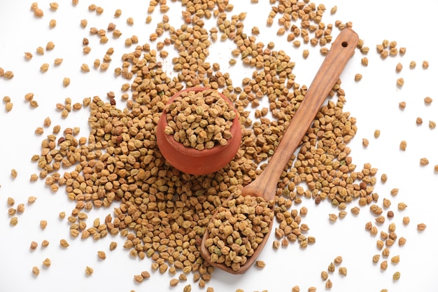 Dried chickpeas in bowl isolated on white background.