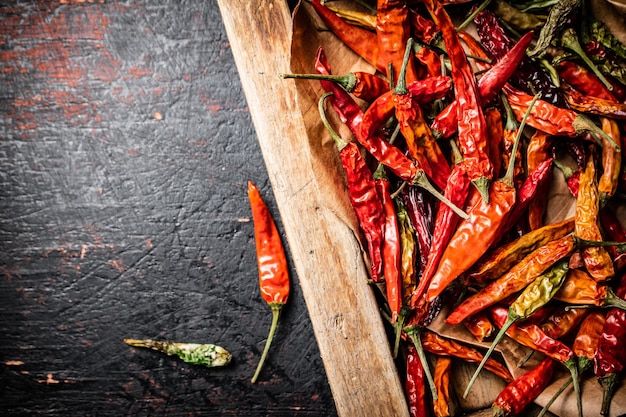 Dried chili peppers in a wooden tray