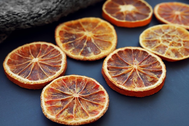 Dried citrus slices on dark surface