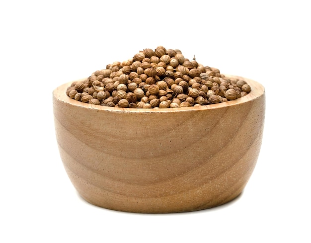 dried coriander seeds with bowl wooden isolated on white background