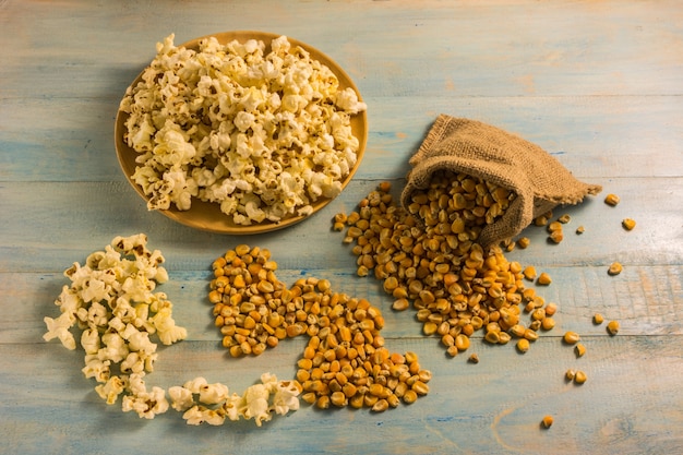 Dried corn and popcorn on a wooden table