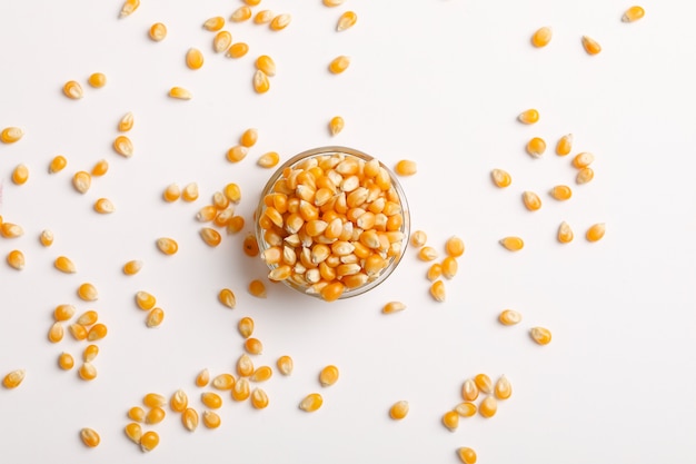 Dried corn seeds in bowl on white  