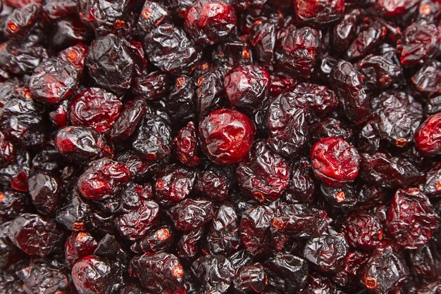 Dried cranberries texture food background Heap of sweet red berries closeup