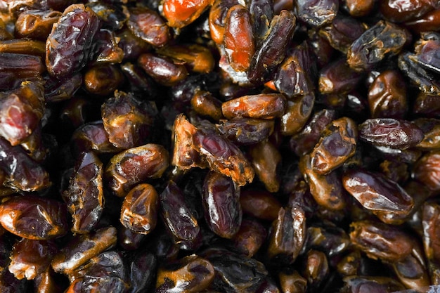 Photo dried date fruits in the box , dates background