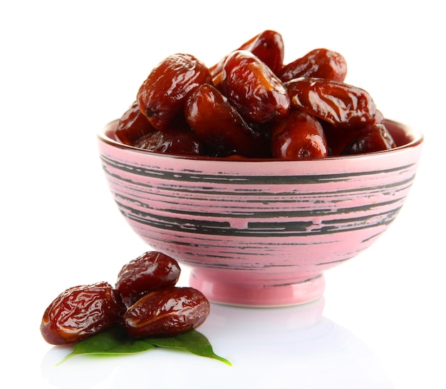 Dried dates in bowl isolated on white