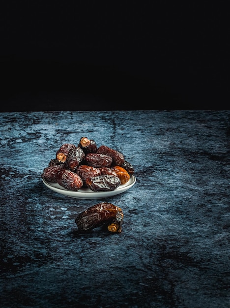 Dried dates fruit on dark background