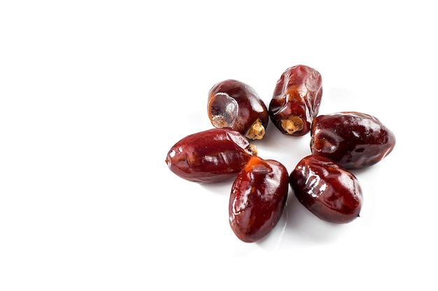 Dried dates fruit on white background.