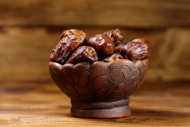 Dried dates fruit on wooden table