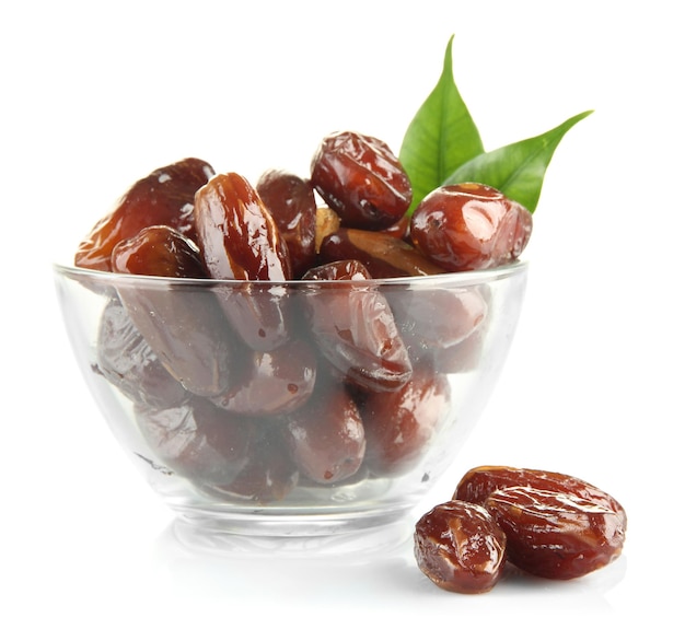 Dried dates in glass bowl isolated on white