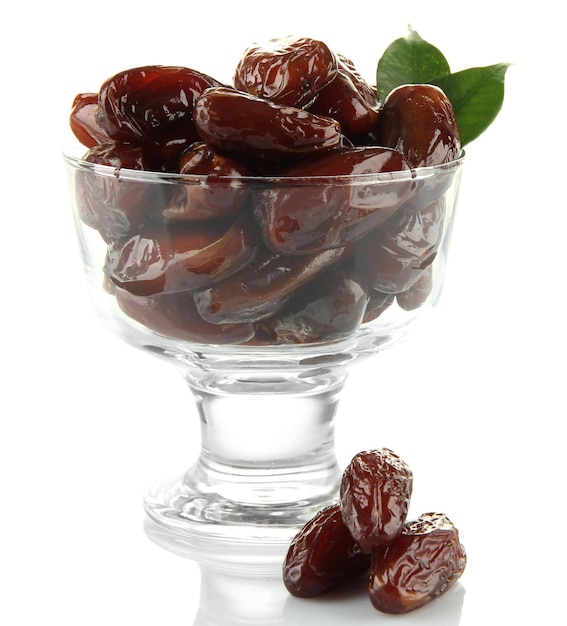 Dried dates in glass bowl isolated on white