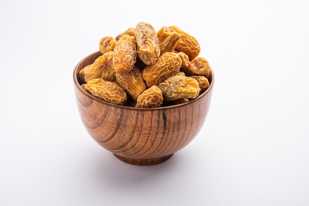 Dried Dates or sukha khajur or khajoor served in a bowl selective focus