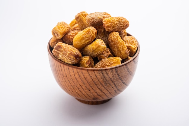 Dried Dates or sukha khajur or khajoor served in a bowl selective focus