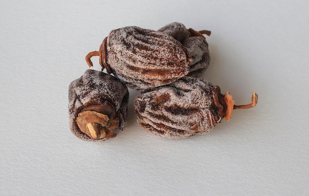 Dried dates on a white background . Its Turkish name is persimmon persimmon.