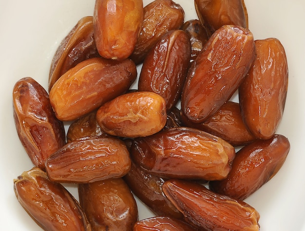 Dried dates on a white bowl