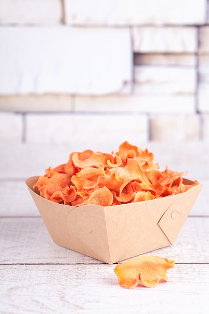 Photo dried dehydrated carrot chips. delicious organic eco-friendly snack for the whole family. healthy eating concept.