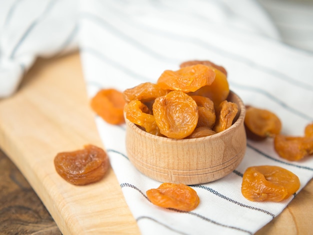 Dried dried apricots in a bowl on an old wooden table dried fruits