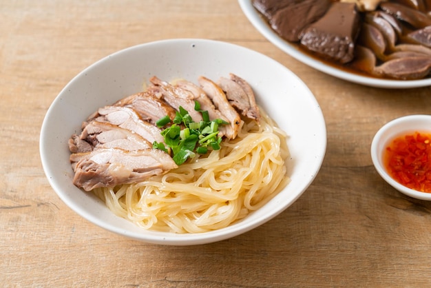 Dried duck noodles in white bowl