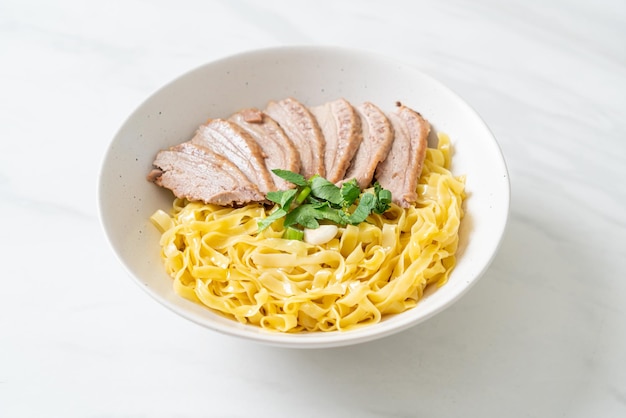 Dried duck noodles in white bowl