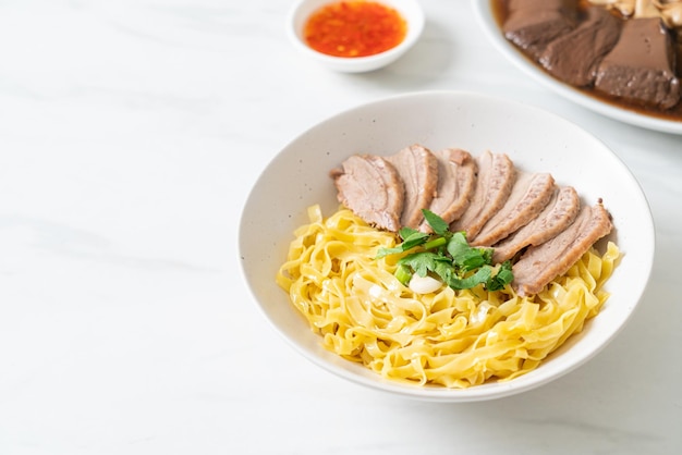 Dried duck noodles in white bowl