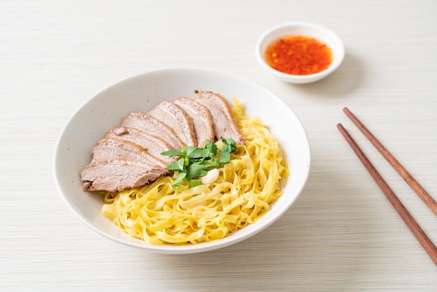 Dried duck noodles in white bowl