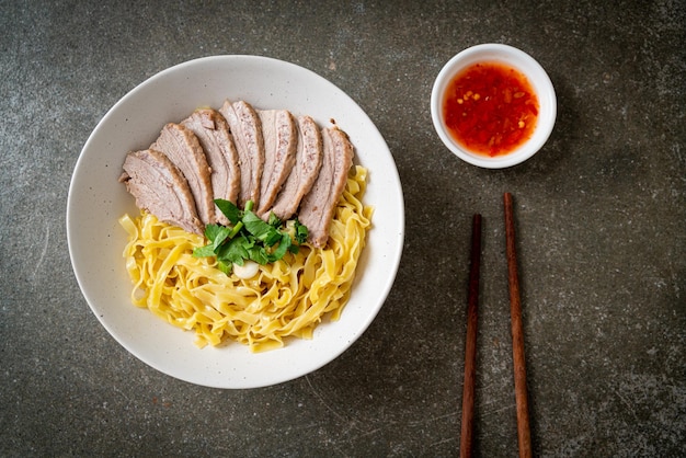 Dried duck noodles in white bowl