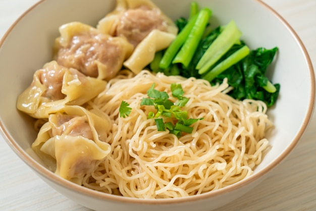 dried egg noodles with pork wonton or pork dumplings without soup Asian food style