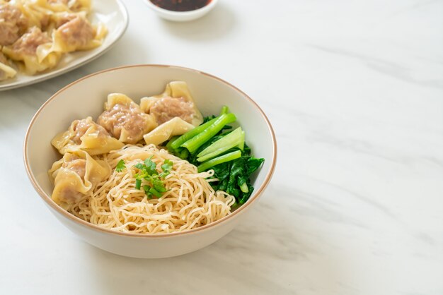 Dried egg noodles with pork wonton or pork dumplings without soup Asian food style