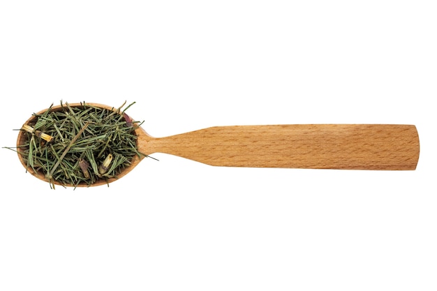 Photo dried equisetum arvense in a wooden spoon on a white background.