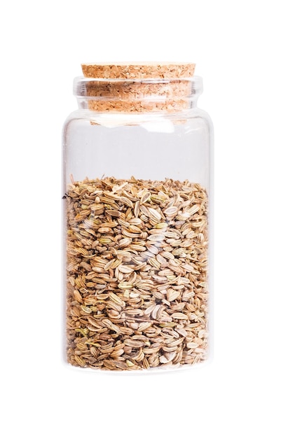 Dried fennel seeds in a bottle with cork stopper for medical use