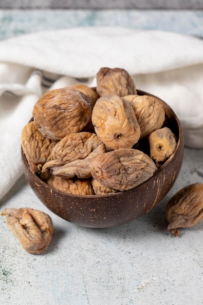 Dried figs on stone background Sundried dried figs in glass bowl Diet foods close up