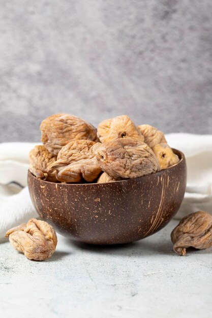 Dried figs on stone background Sundried dried figs in glass bowl Diet foods close up