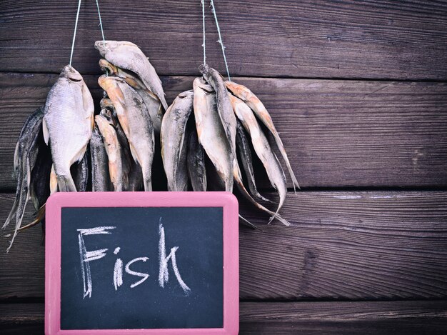 Photo dried fish hangs on a rope