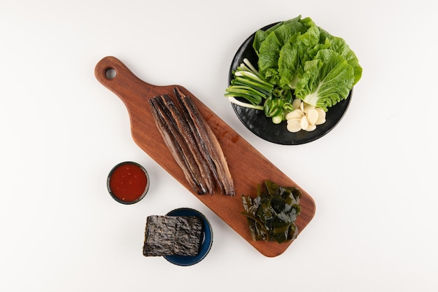 dried fish and vegetables on a plate