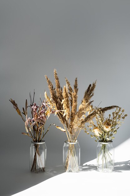 Photo dried flowers bouquets in plastic bottles to reduce waste aesthetic eco friendly home decor